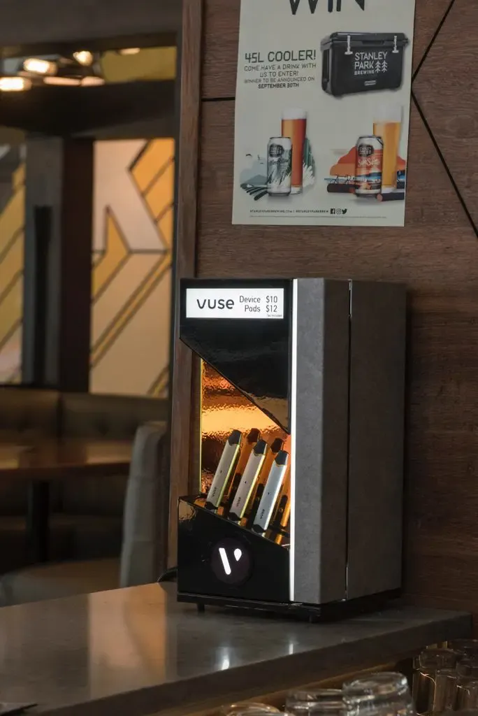 Vuse-branded backbar lit on counter, design DNA carried through